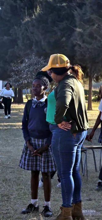 A mentor speaking privately with a schoolgirl